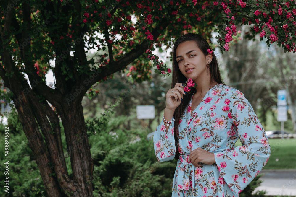 Well dressed attractive mixed race young woman posing on the park background Well dressed attractive mixed race young woman posing on the park background