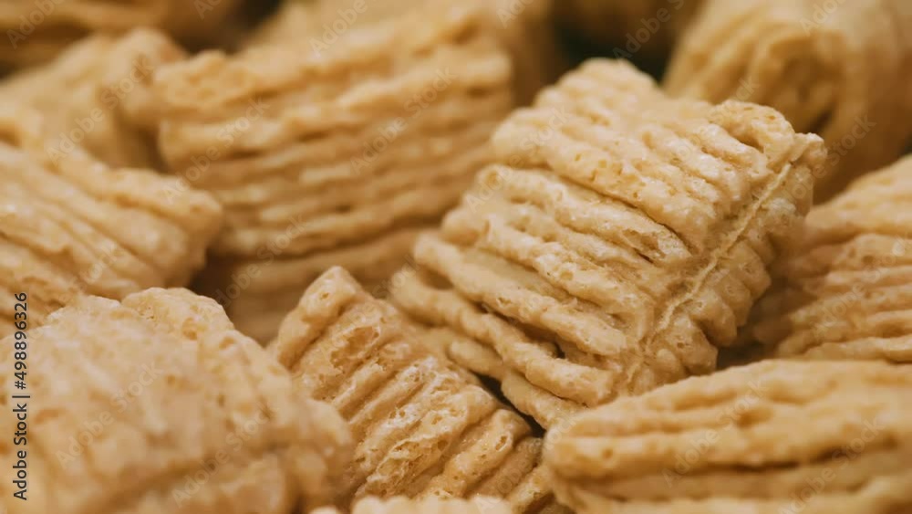 Oat Square Breakfast Cereal rotating in bowl Close Up Group Macro Oat Square Breakfast Cereal rotating in bowl Close Up Group Macro