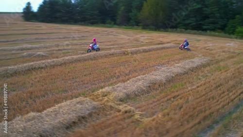 Aerial view of motocrossing landscapes. Motorcycle drivers traveling on a country road. photo