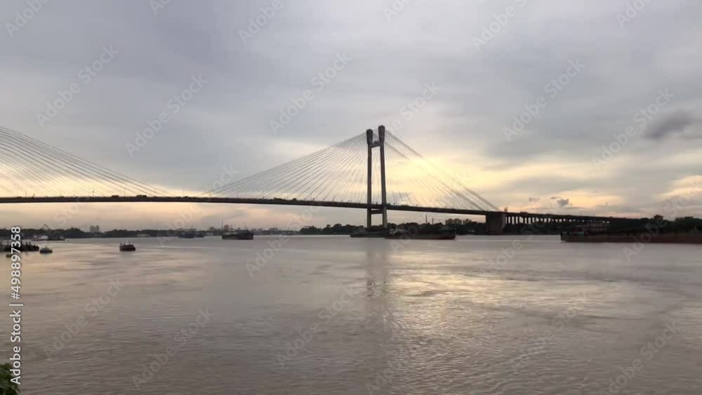 4K Timelapse of beautiful clouds over Kolkata city with a view of Vidyasagar Setu on the Ganga river in West Bengal, India. 4K Timelapse of beautiful clouds over Kolkata city with a view of Vidyasagar Setu on the Ganga river in West Bengal, India.