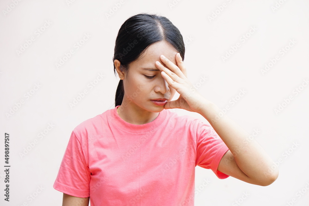 Asian women suffer from work stress. Put your hand on your head
