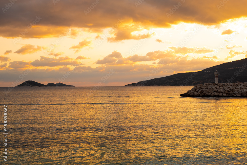 Breathtaking colorful orange sunset at Mediterranean sea, reflecting in water.Beautiful seaside,coastline.Copy space.Beauty in nature concept