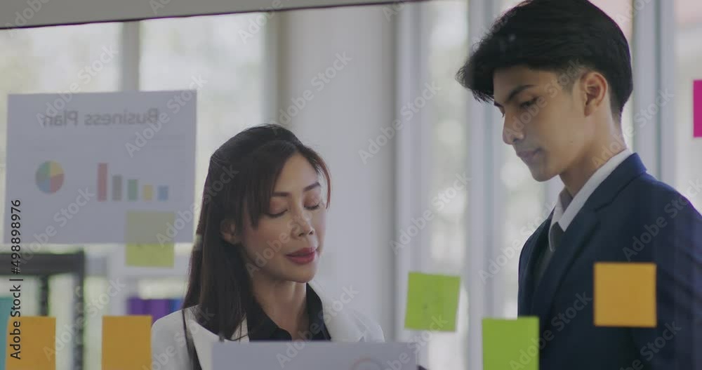 Businesspeople brainstorming with Adhesive Note Businesspeople brainstorming with Adhesive Note