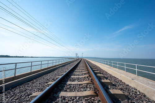 Area of Railroad tracks with floating railway bridge over water reservoir at Pa Sak Cholasit Dam, Lopburi, Thailand.