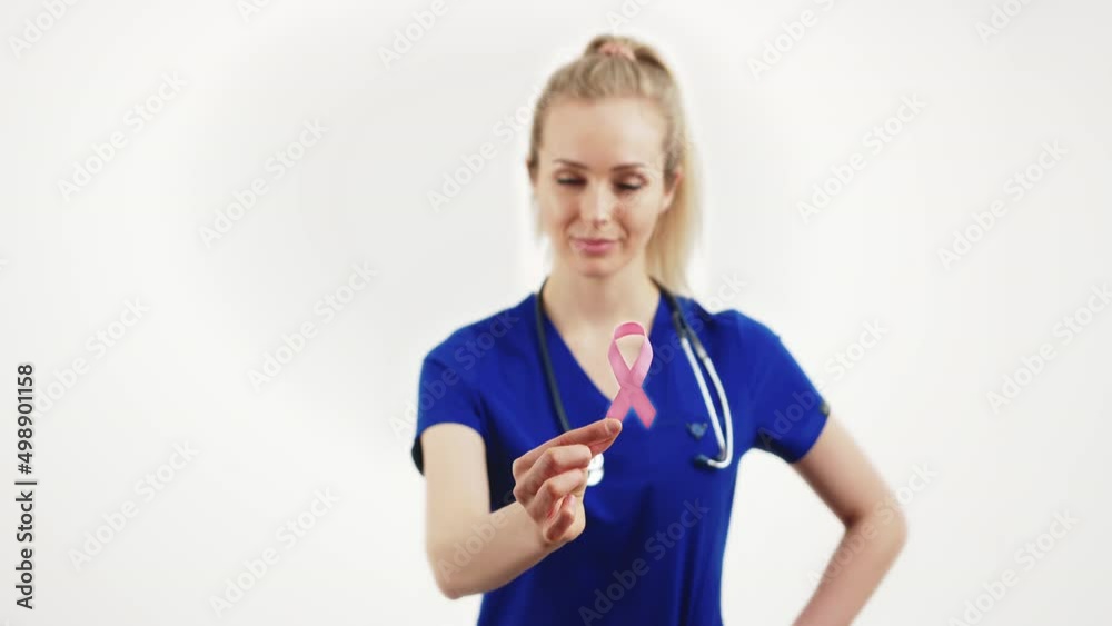 Fight against HIV, AIDS. Healthcare professional female worker in a blue uniform showing red ribbon with her fingers. Medium studio shot. High quality 4k footage Fight against HIV, AIDS. Healthcare professional female worker in a blue uniform showing red ribbon with her fingers. Medium studio shot. High quality 4k footage