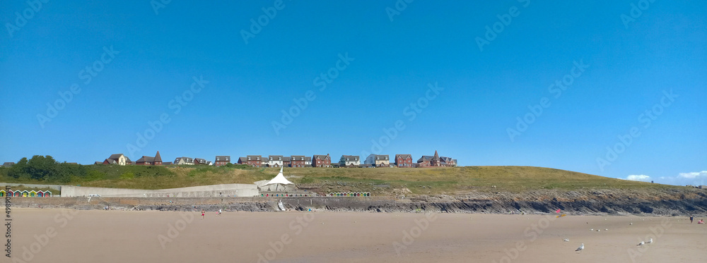 beautiful beach landscape near Barry, Wales, United Kingdom with hill top houses