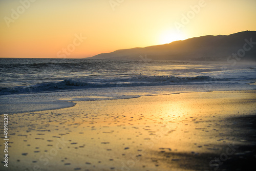 Panoramic sea ocean sunrise. Landscape of sea and tropical beach at sunset or sunrise time for leisure travel and vacation. Reflection of sun in the water and sand on beach.