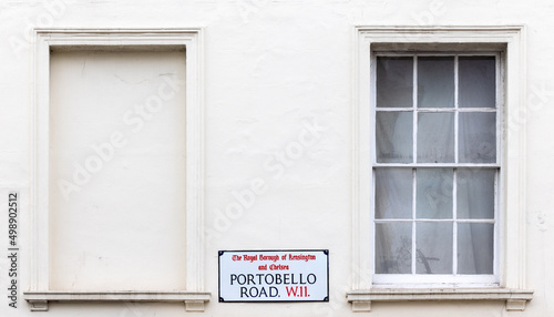Street sign on a white painted wall, Portobello Road, London. Site of the famous street market.
