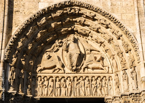 Fototapeta Statue of Jesus Christ surrounded by Four Evangelists (represented as winged man,  lion, ox and eagle) and angels above the entrance to the Cathedral of Chartres, France