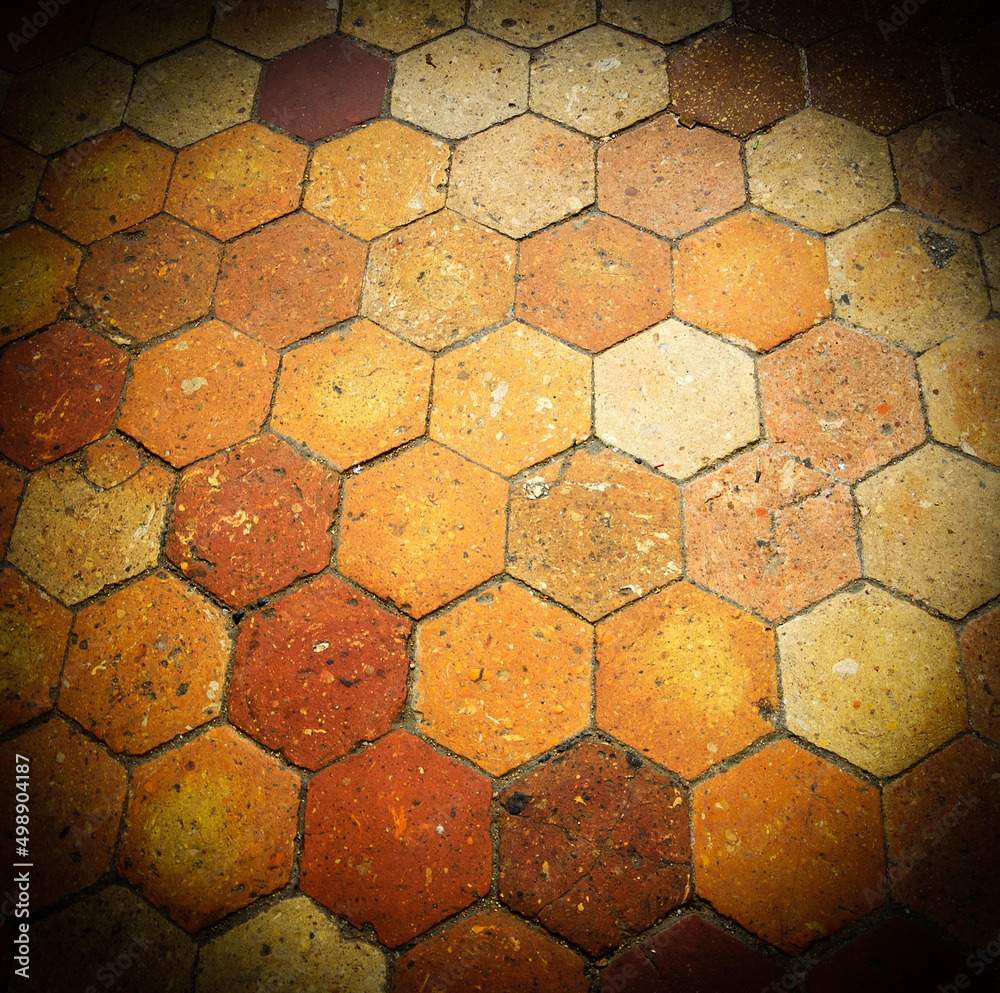 Old terracotta tile floor. Honeycomb pattern. 