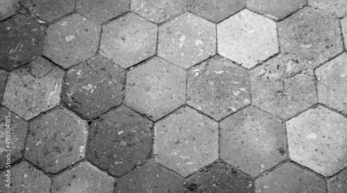 Old terracotta tile floor. Honeycomb pattern. Black white historic photo.