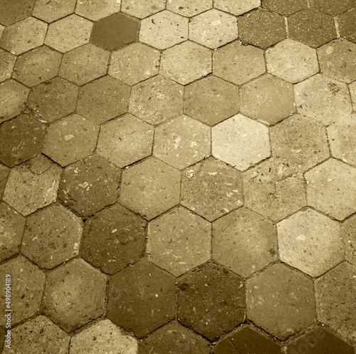 Old terracotta tile floor. Honeycomb pattern. Sepia historic photo.