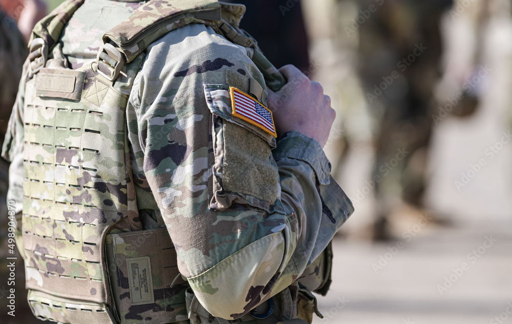 Detail view of the US Army uniform worn by soldiers in a military base. Flag of America on the uniform.