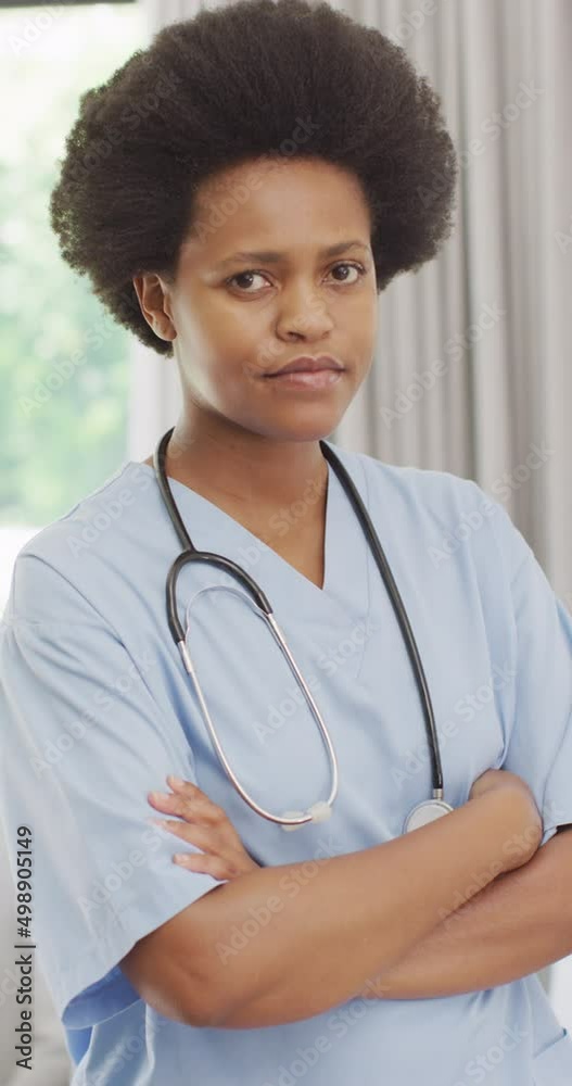 Vertical video of portrait of african american female doctor with arms crossed Vertical video of portrait of african american female doctor with arms crossed