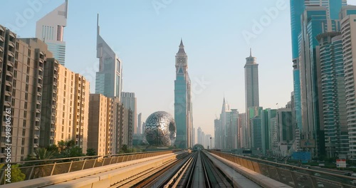 Dubai, UAE, United Arab Emirates. Monorail POV Subway train rides among skyscrapers. Dubai, UAE, United Arab Emirates. Monorail POV Subway train rides among skyscrapers, Museum of the Future in Dubai.