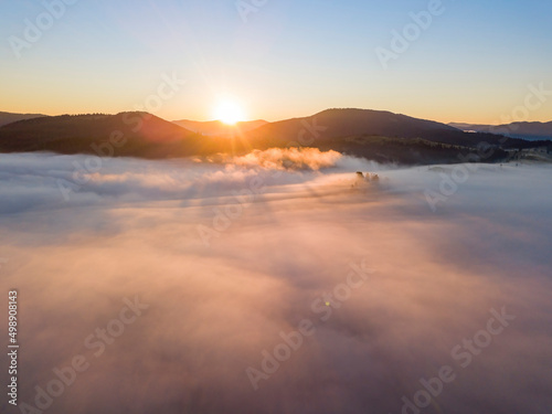 Sunrise over the fog in the Ukrainian Carpathians. Aerial drone view.