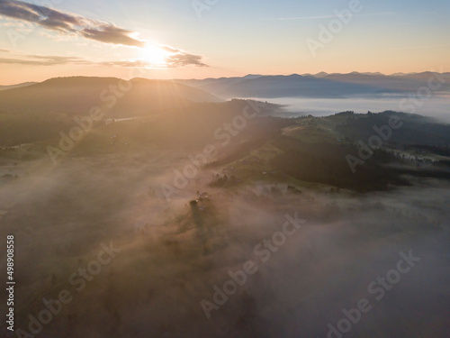 Sunrise over the fog in the Ukrainian Carpathians. Aerial drone view.