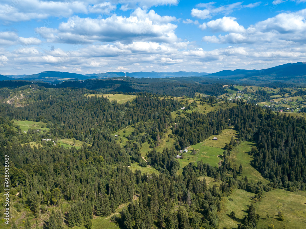 Fototapeta premium Green mountains of Ukrainian Carpathians in summer. Coniferous trees on the slopes. Aerial drone view.
