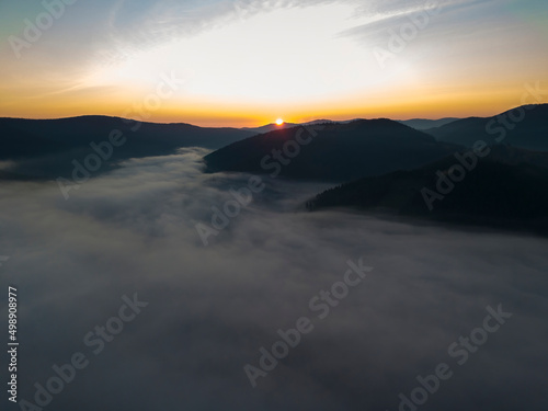 Sunrise over the fog in the Ukrainian Carpathians. Aerial drone view.