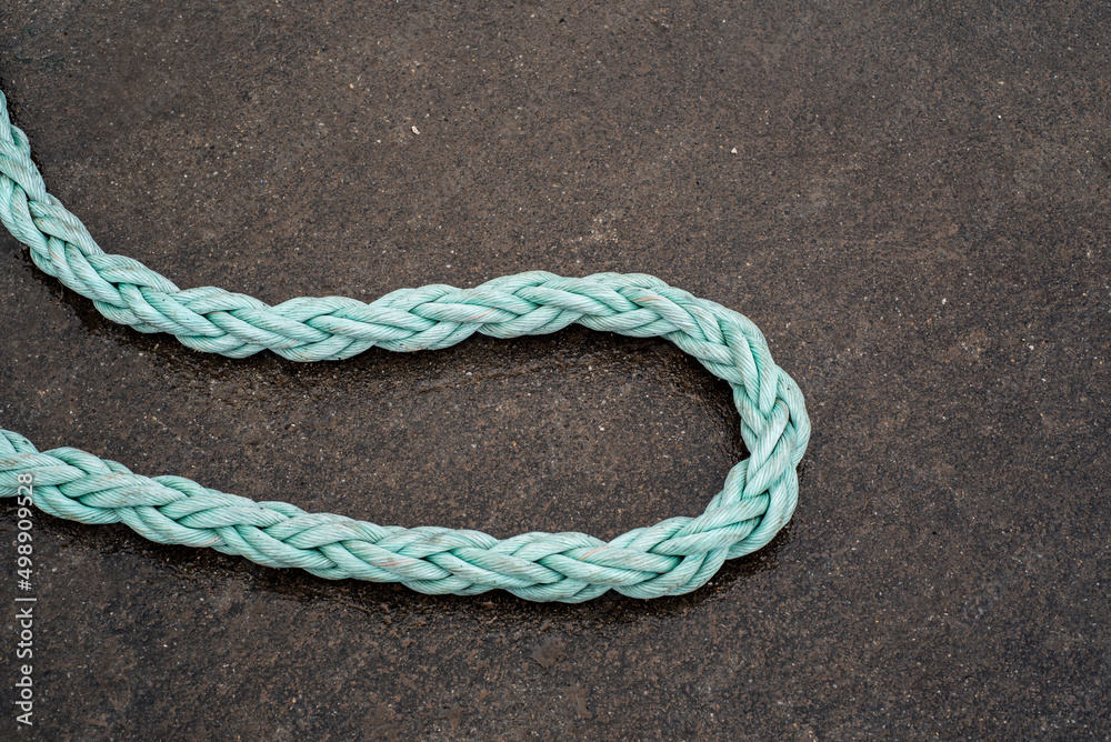 Old ropes on the ground of the fishing port Old ropes on the ground of the fishing port