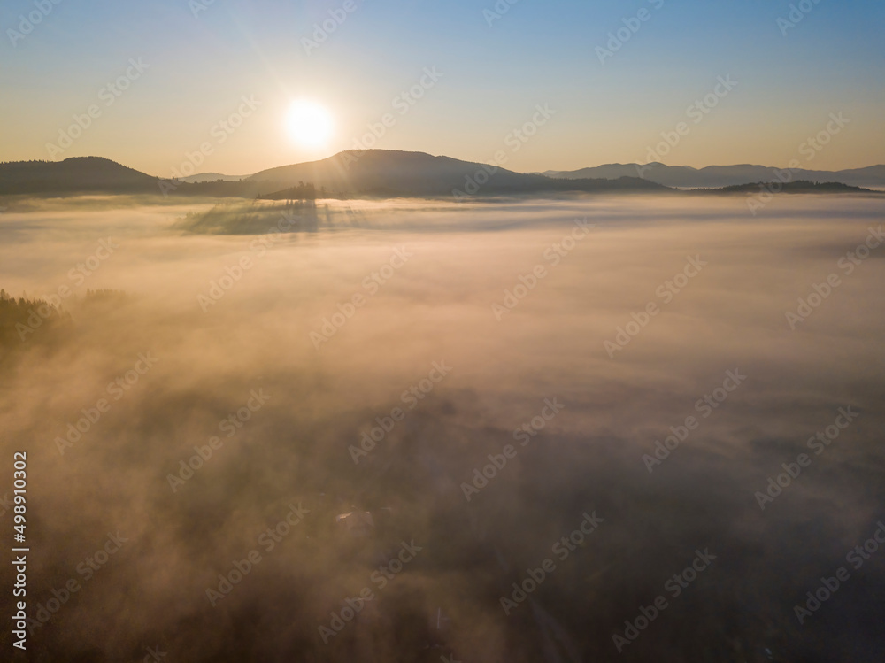 Morning mist in Ukrainian Carpathian mountains. Aerial drone view.