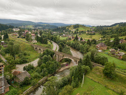 Old railway bridge in the mountains. Ukrainian Carpathians. Aerial drone view.