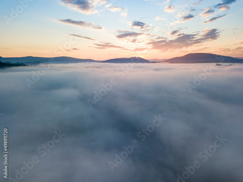 Sunrise over the fog in the Ukrainian Carpathians. Aerial drone view.