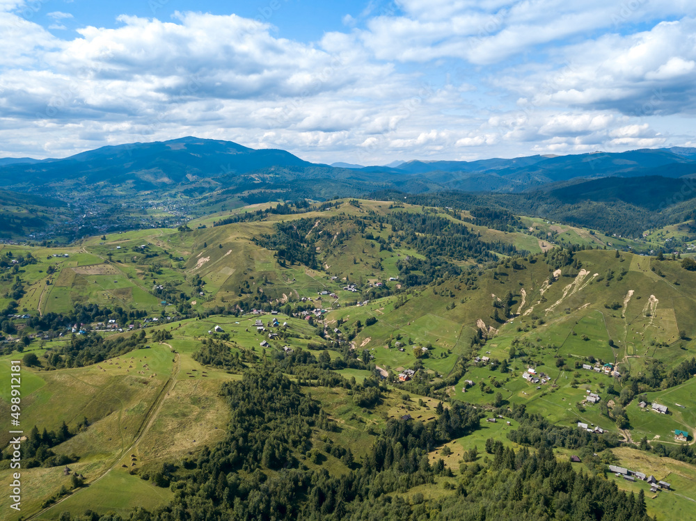 Green mountains of Ukrainian Carpathians in summer. Coniferous trees on the slopes. Aerial drone view. Green mountains of Ukrainian Carpathians in summer. Coniferous trees on the slopes. Aerial drone view.