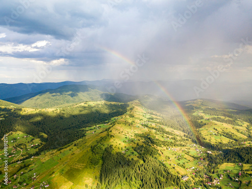 Rainbow in the mountains of the Ukrainian Carpathians. Aerial drone view.