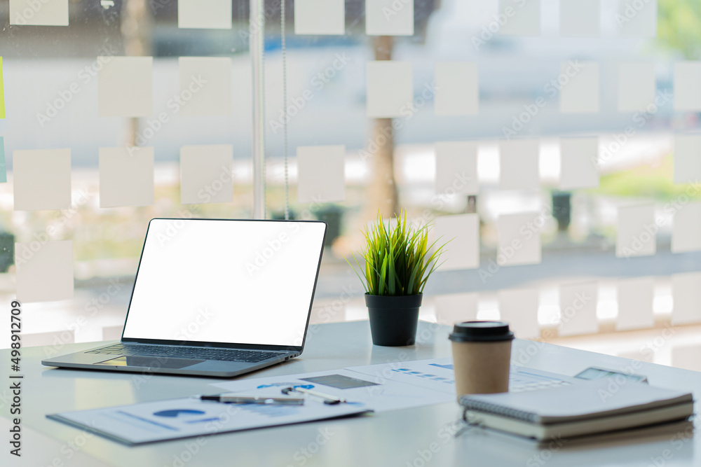 laptop computer with a white screen and financial graph on the ...