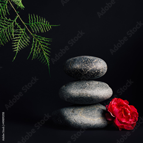 Luxurious empty stacked zen stone podium and orchid flower on dark black background. Concept scene stage for promotion  sale  presentation or cosmetic. Black minimal mock up template for spa salon.