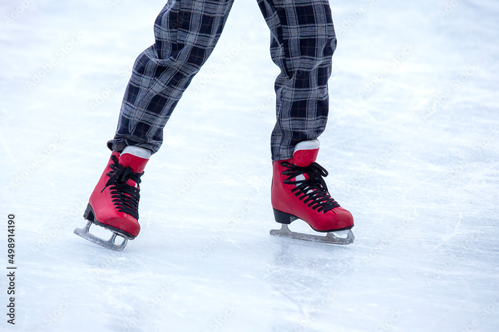 feet on skates on an ice rink. winter sport and recreation feet on skates on an ice rink. winter sport and recreation