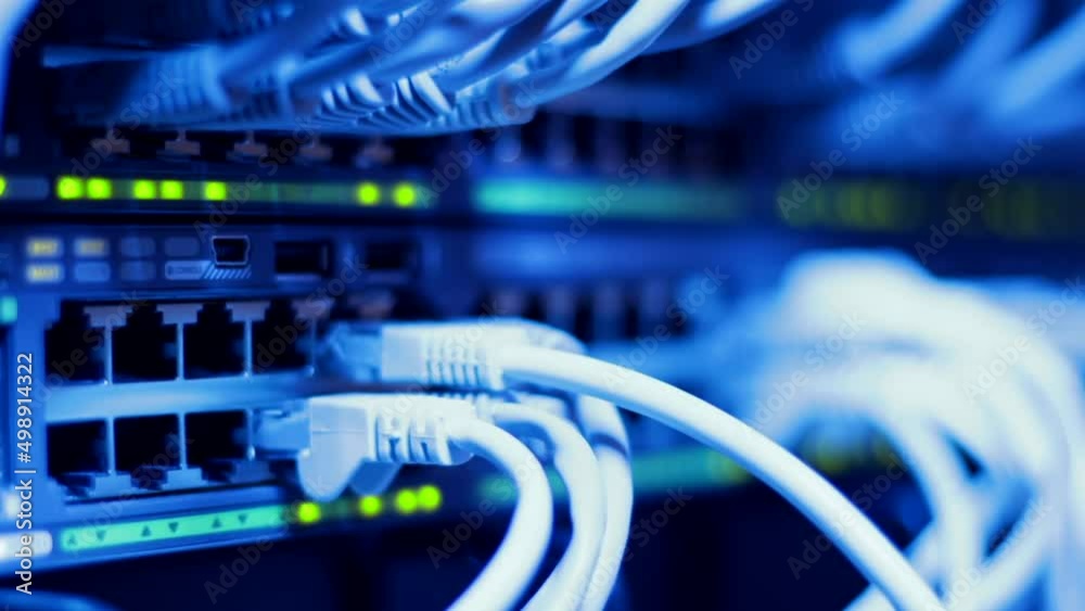 IT engineer connecting client cables to large professional LAN switch