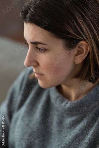 mental health, psychological problem and depression concept - close up of sad crying woman at home