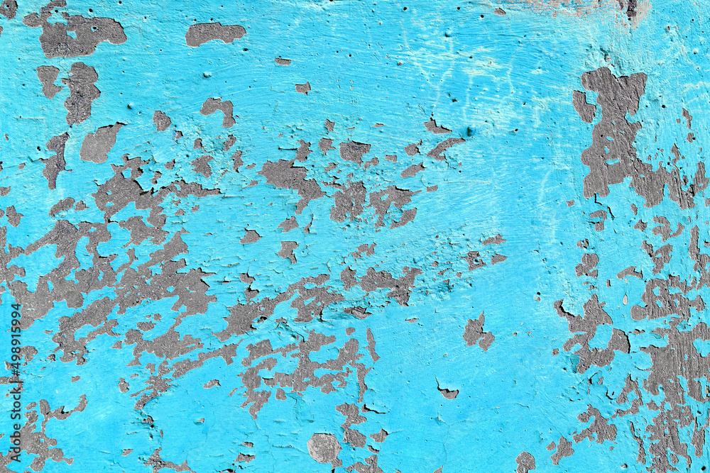 Old blue cracked paint on a concrete wall with a hole Old blue cracked paint on a concrete wall with a hole