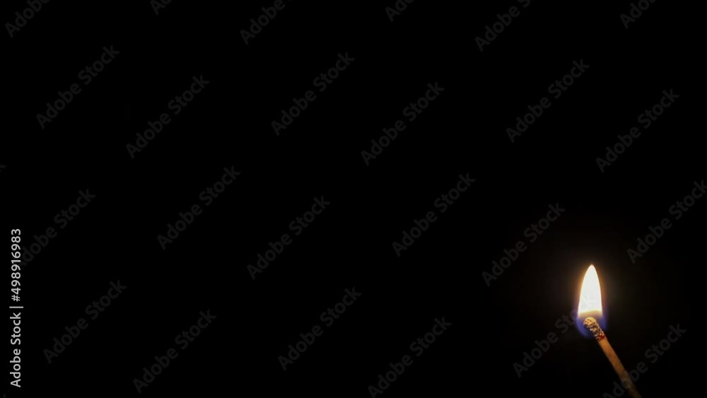 Burning match. Full HD slow-motion video of burning match in the corner isolated on a black background. Burning match. Full HD slow-motion video of burning match in the corner isolated on a black background.
