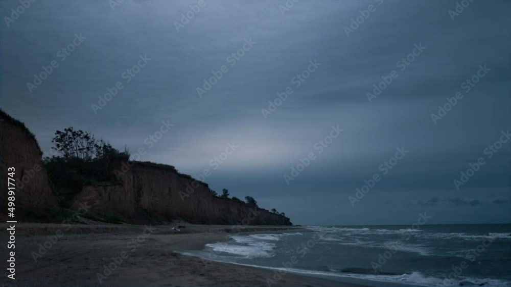 Dark sea coast wave breaking evening beach landscape. Ocean nature background. Dark sea coast wave breaking evening beach landscape. Ocean nature background.