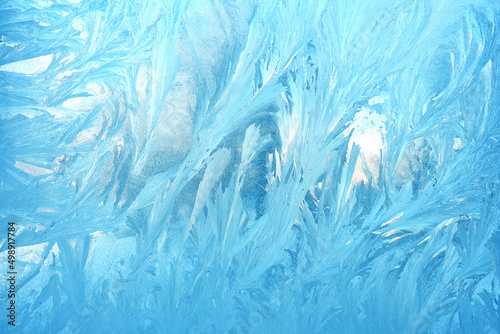 frosty patterns on the window glass closeup. natural textures and backgrounds. ice patterns on frozen