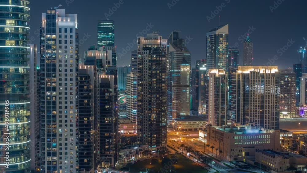 Dubai's business bay towers aerial night timelapse. Rooftop view of some skyscrapers Dubai's business bay towers aerial night timelapse. Rooftop view of some skyscrapers
