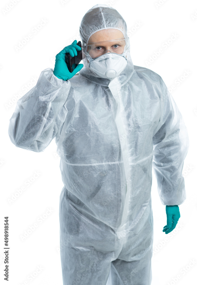 a man in special protective clothing is phoning. isolated a man in special protective clothing is phoning. isolated