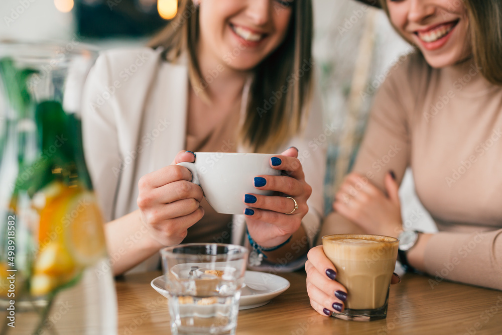 women are having coffee break in cafeteria women are having coffee break in cafeteria