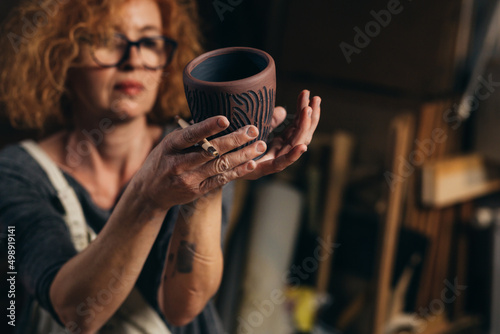 woman is making pottery in her workshop