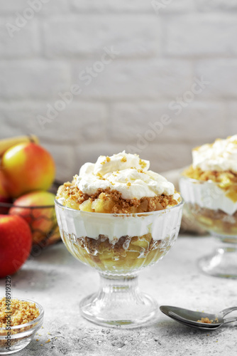 Apple trifle in a glass bowl on a light culinary background. Traditional Scandinavian aebletrifli on the kitchen table