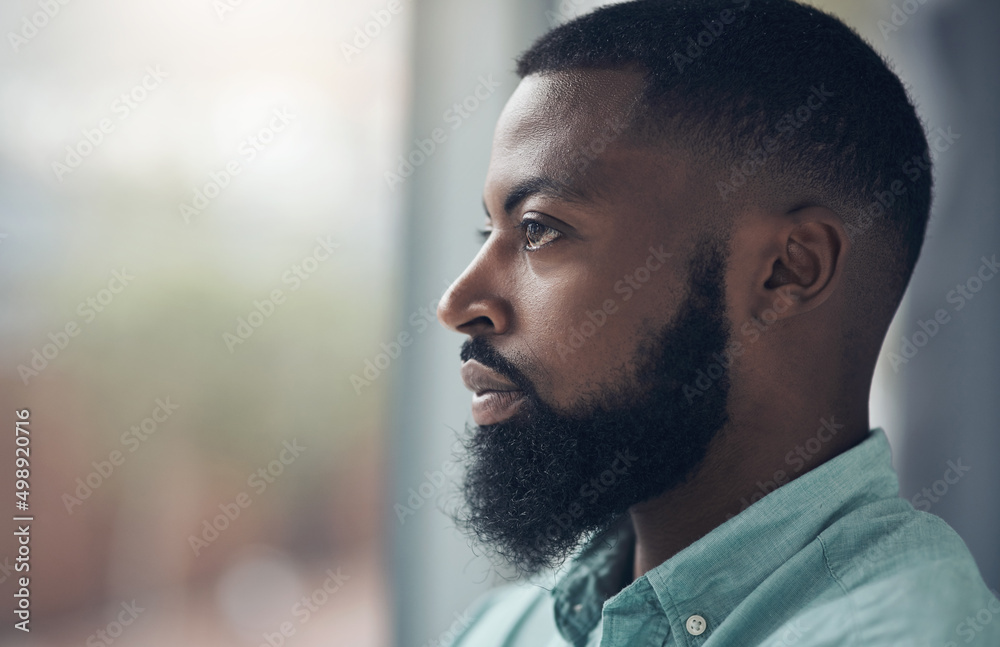Stay true to the vision. Shot of a handsome young businessman standing alone in his office and looking outside his window contemplatively. Stay true to the vision. Shot of a handsome young businessman standing alone in his office and looking outside his window contemplatively.