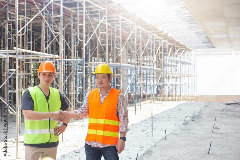 Naklejka premium Three engineers working in a construction site