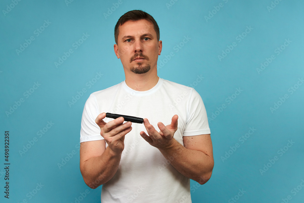 Man with lancet pen doing diabetes test, close-up Man with lancet pen doing diabetes test, close-up