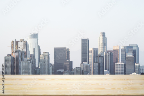 Blank table top made of wooden planks with beautiful Los Angeles cityscape at daytime on background  mockup