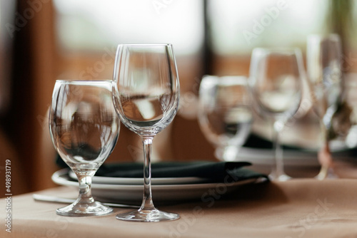 Table in a restaurant with cutlery. Plates and glasses for wine and water