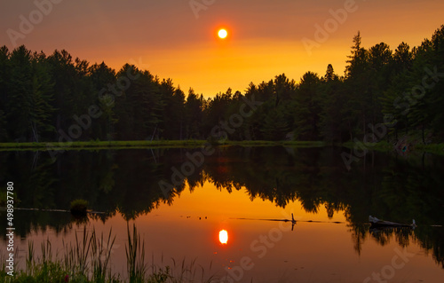 An autumn sunset over a marshy pond in Algonquin Park, Canada