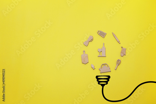 Creative thinking ideas and innovation concept. A ball of food preparation items with a light bulb symbol on a yellow background.